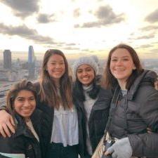 Vicki Moran and three friends in front of city skyline